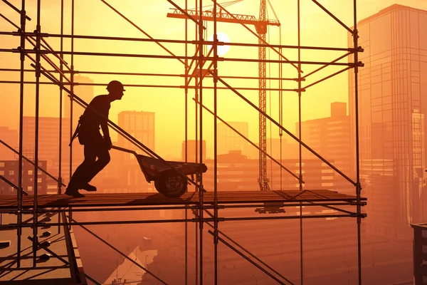 Silhouette Eines Arbeiters Mit Einer Schubkarre Auf Einer Baustelle — Stockfoto