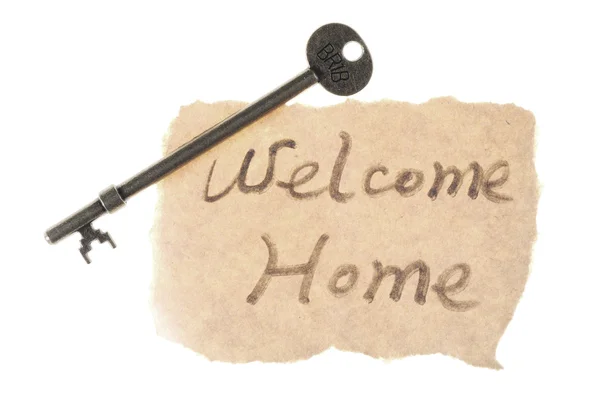 Old key and welcome home words — Stock Photo, Image