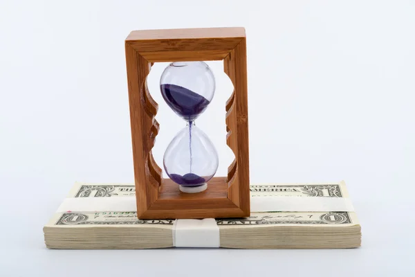 Hourglass on money — Stock Photo, Image