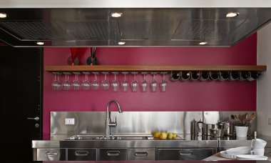 Modern steel kitchen with purple wall clipart