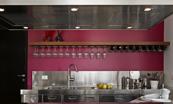 Modern steel kitchen with purple wall