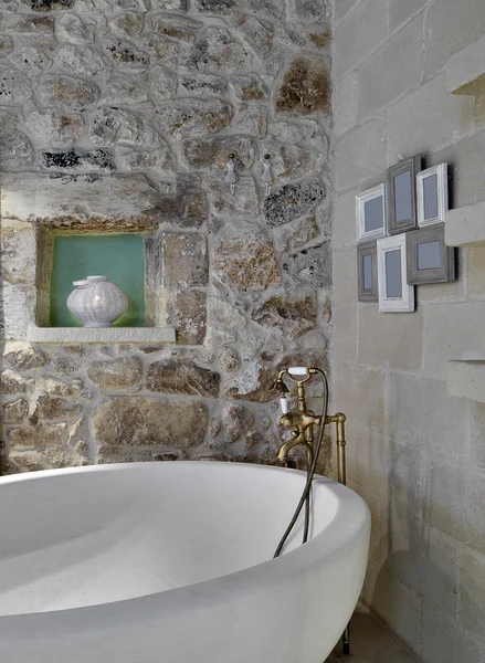 Detail of bathtub in a rustic bathroom — Stock Photo, Image