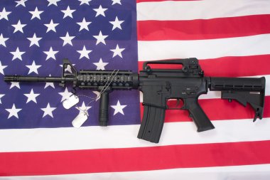 M4A1 assault rifle with blank dog tags on us flag clipart