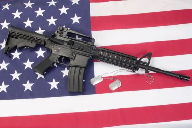 M4A1 carbine with blank dog tags on us flag clipart