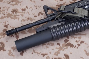 m4 carbine on camouflage uniform clipart