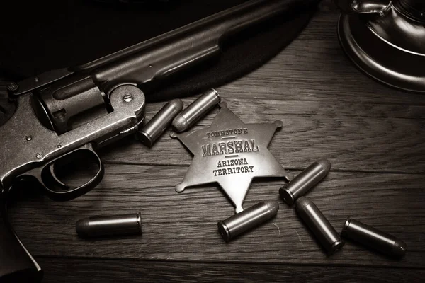 Old West Marshals Badge Revolver Cartridges Wooden Table — Photo