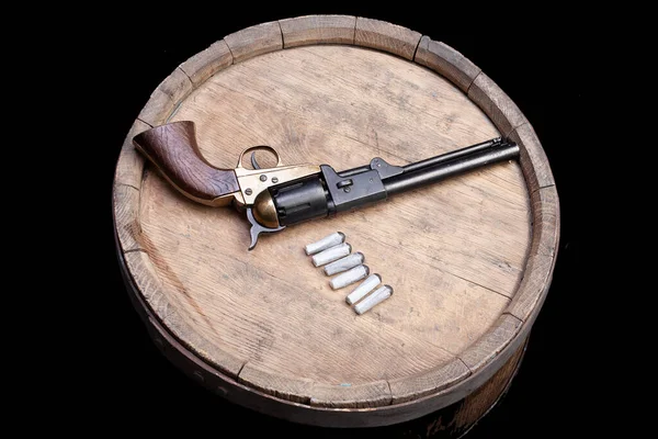 Old West Gun - Percussion Army Revolver and paper cartridges with lead ball as projectiles on wooden barrel