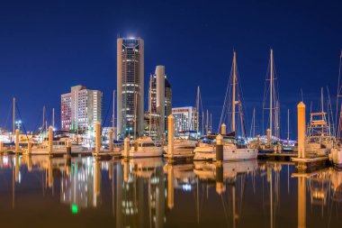 Corpus Christi, Texas, USA downtown skyline on the water at twilight with boats. clipart