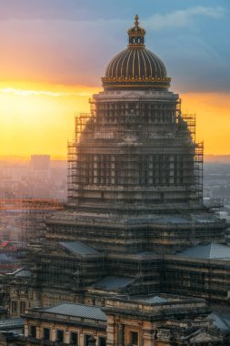 Brussels, Belgium cityscape at the Palais de Justice dome covered in decades old scaffolding at dusk.