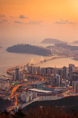 Skyline of Busan, South Korea from above at dusk.
