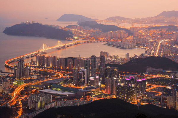 Skyline of Busan, South Korea from above at dusk.