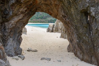 okashiki Island, Okinawa, Japan at Aharen Beach and the natural stone arch.
