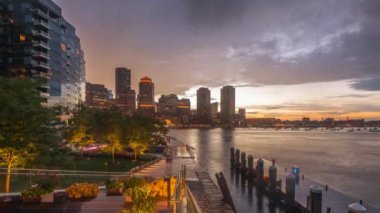 Boston, Massachusetts, USA downtown city skyline and pier at twilight.