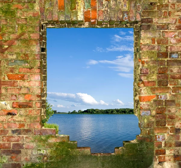 Window in a brick wall with a kind on the river — Stock Photo, Image
