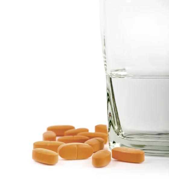 Vitamins with glass of water — Stock Photo, Image