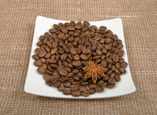 Coffee bean are spilled on a saucer with a anise — Stock Photo, Image