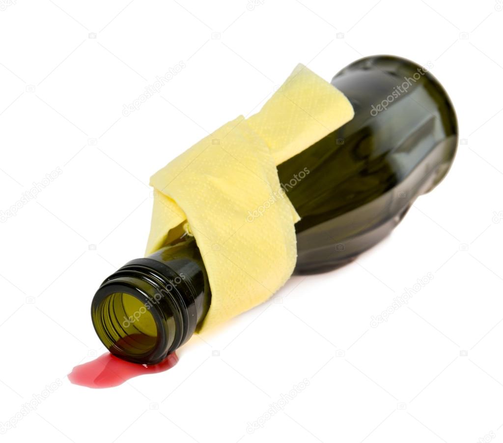 Spilled wine from a bottle on a white background