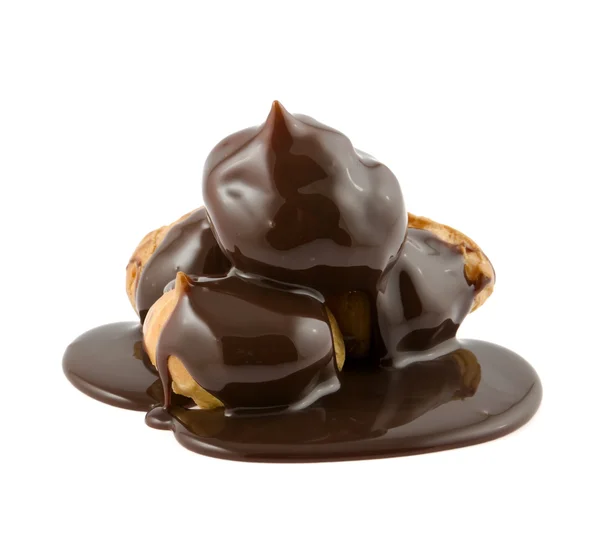 Profiteroles in a chocolate on a white background — Stock Photo, Image