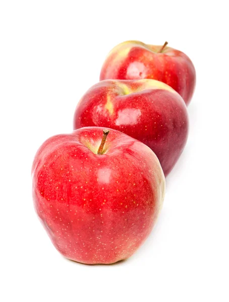 Three red apples stand in one row on a white background Stock Photo