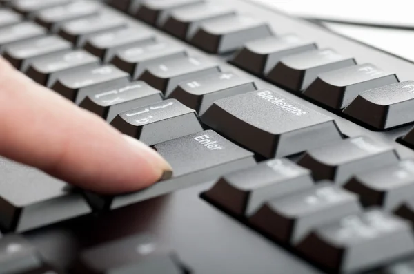 Finger women presses a key on the keyboard macro — Stock Photo, Image