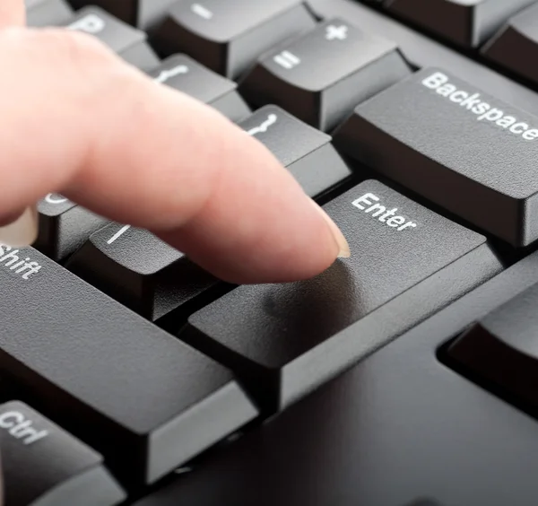 Finger women presses a key on the keyboard macro — Stock Photo, Image