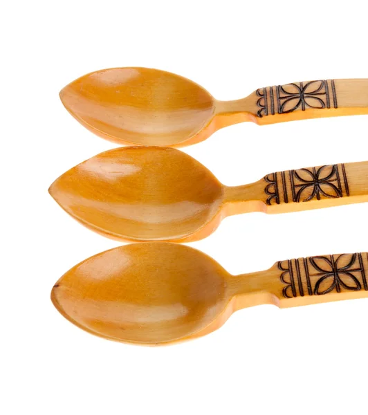 Three wooden spoons on the white — Zdjęcie stockowe