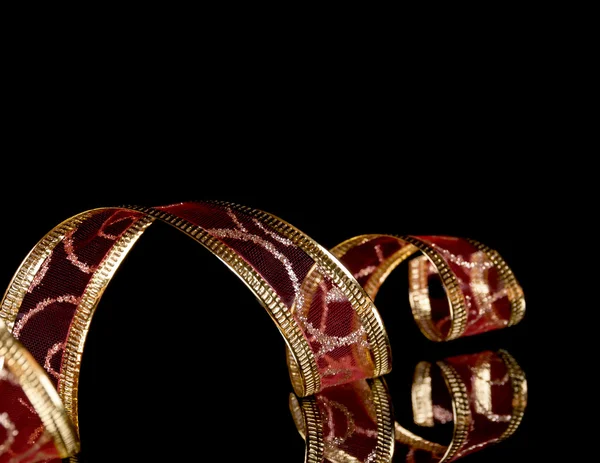 Background of the tracery of red tape on the black with the reflection — Stock Photo, Image