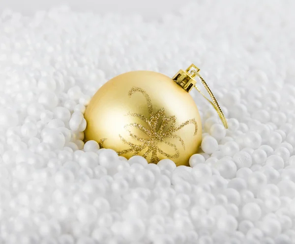 Yellow fir-tree toy lies in white marbles — Stock Photo, Image