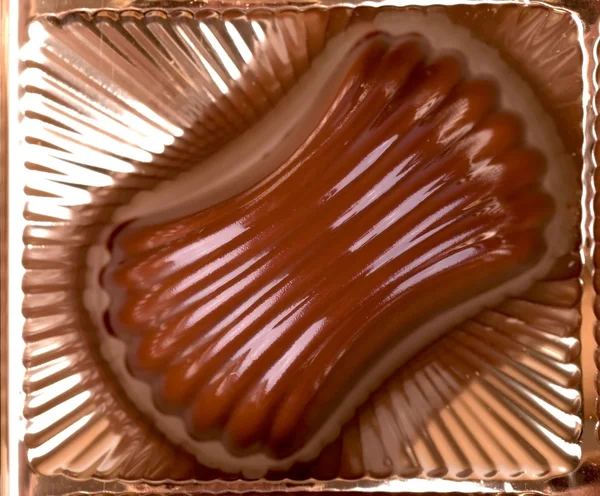 Chocolate candy lies in the cell box macro — Stock Photo, Image