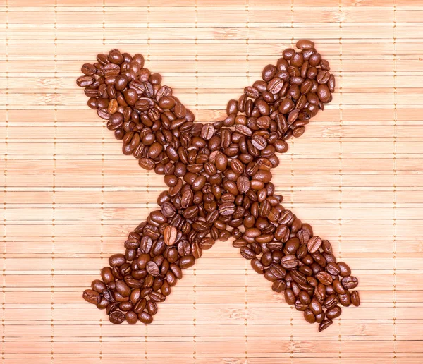cross of coffee beans on a decorative straw