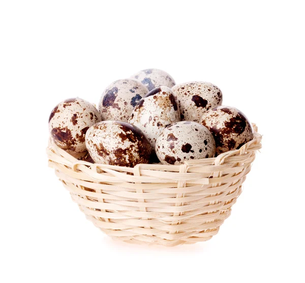 Quail eggs in a basket on the white — Stock Photo, Image