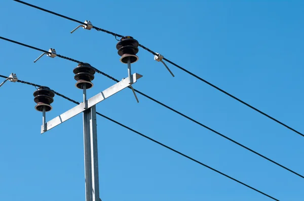 Coil of high voltage cables against the blue sky — Stock Photo, Image