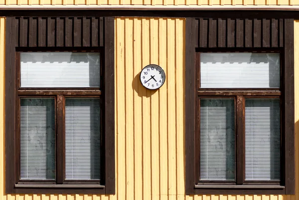 The yellow wooden wall of the two windows — Stock Photo, Image