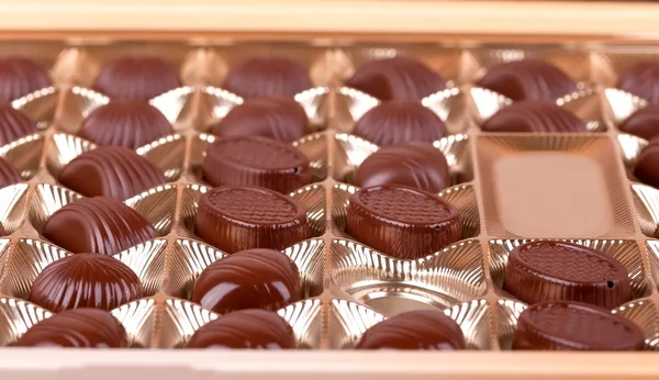 Chocolate sweets lie in the cells of the boxes — Stock Photo, Image