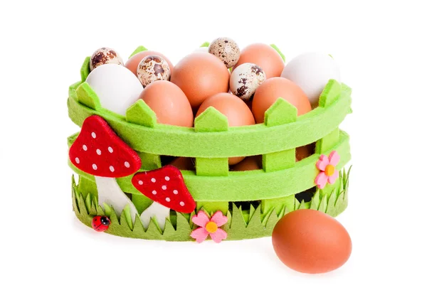 Quail eggs and chicken in green decorative basket on the white — Stock Photo, Image