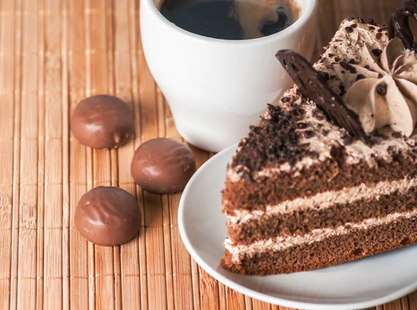 Three sweets with black coffee and a piece of cake — Stock Photo, Image