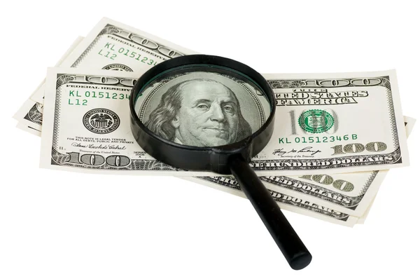 Magnifying glass on the notes of a hundred dollars on white — Stock Photo, Image