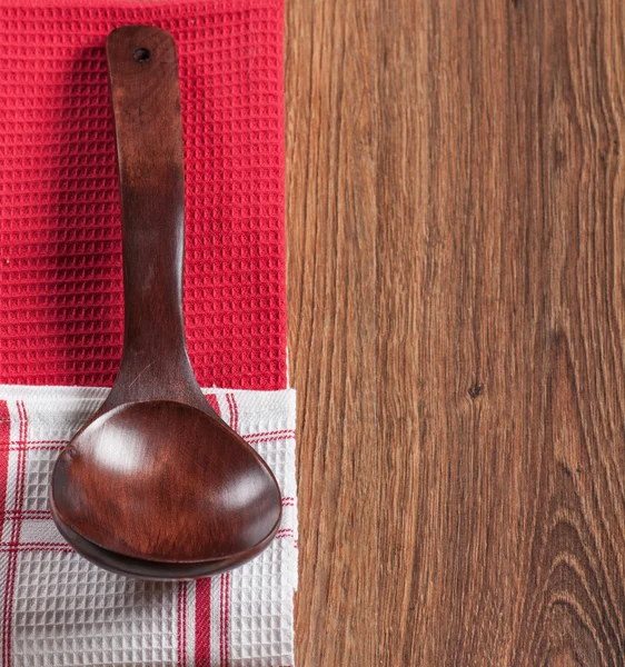 Wooden spoon on a towel — Stock Photo, Image