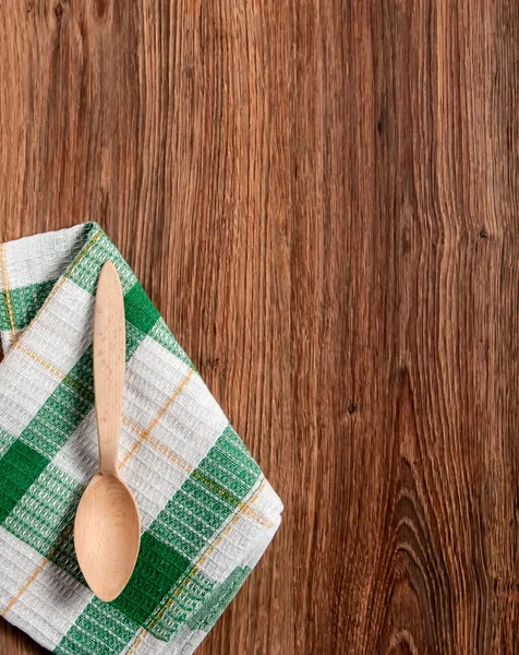 Wooden spoon on a towel — Stock Photo, Image