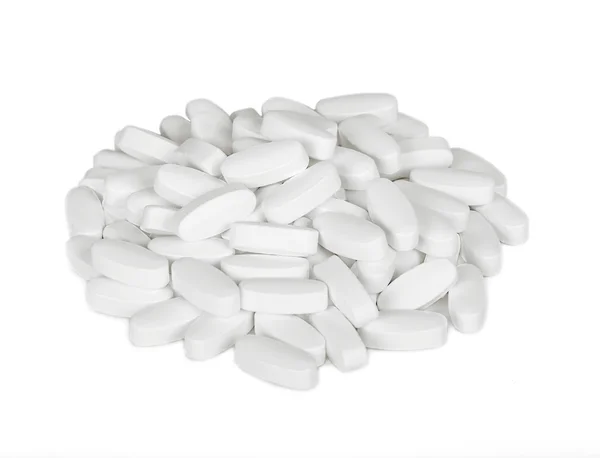 Pílulas brancas são um monte de isolamento — Fotografia de Stock