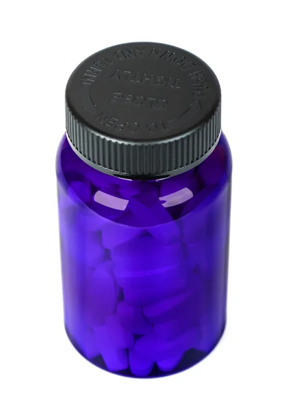 Comprimido branco no frasco azul com uma tampa preta — Fotografia de Stock