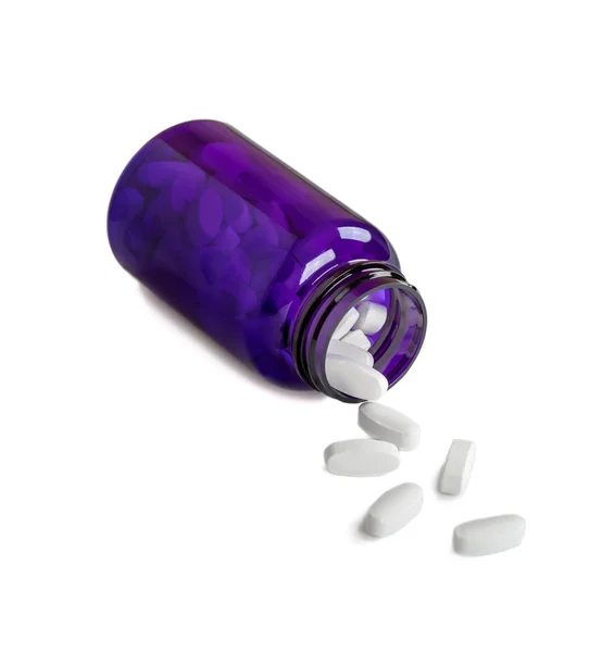 Vita piller hälla ur det blå burk i isolering — Stockfoto