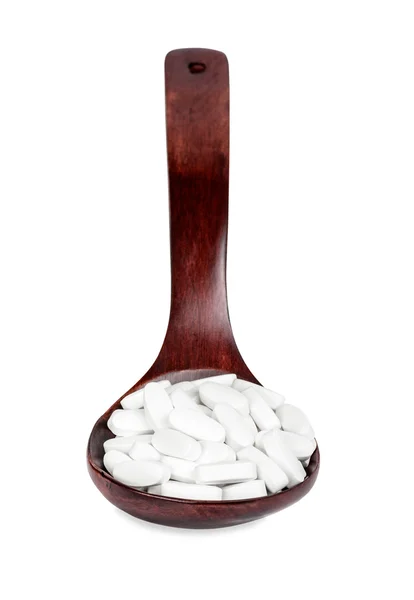 Ξύλινο κουτάλι με χάπια — Φωτογραφία Αρχείου