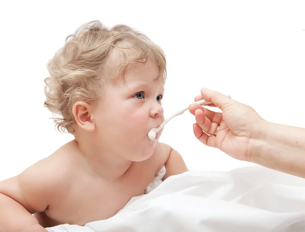 Mother feeds small child with spoon — Stock Photo, Image