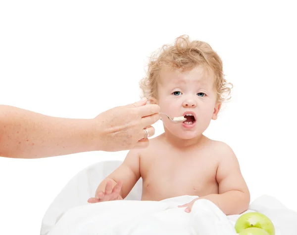 Mother feeds small child  with spoon — Stock Photo, Image