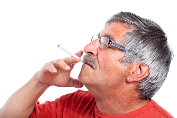 Senior man smoking cigarette — Stock Photo, Image