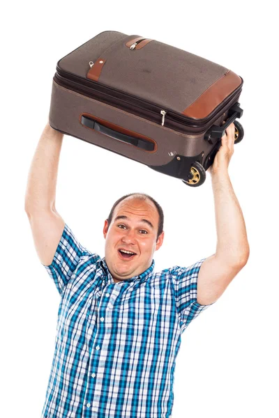 Ecstatic traveler lifting up his luggage — Stock Photo, Image