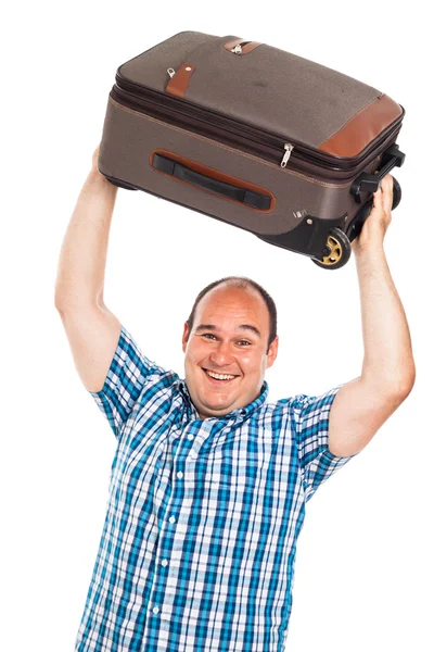 Laughing traveler lifting up his luggage Royalty Free Stock Photos