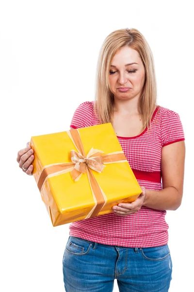 Disappointed woman with present — Stock Photo, Image