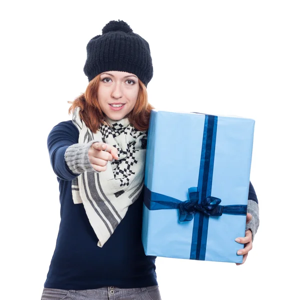 Winter woman with big present pointing — Stock Photo, Image